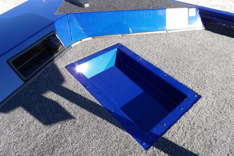 Slide: The Image of 2026 Crestliner XF 189 boat interior with blue storage compartment and gray carpet. - 32