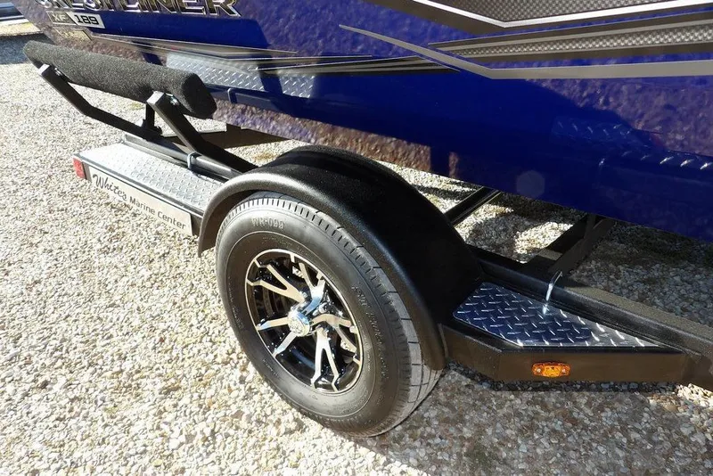 Slide: The Image of 2026 Crestliner XF 189 boat trailer with black wheel and diamond plate step. - 35