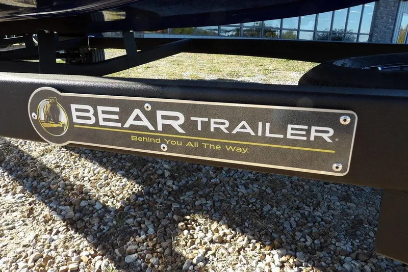 Slide: The Image of Bear Trailer logo on a Crestliner XF 189, 2026 model, parked on gravel. - 36