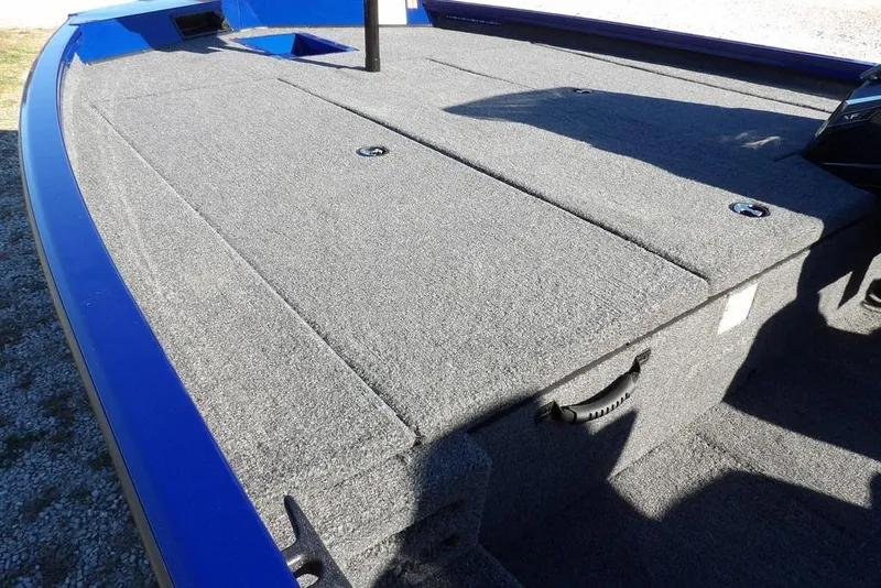 Slide: The Image of 2026 Crestliner XF 189 boat deck with gray carpet and storage compartments. - 8