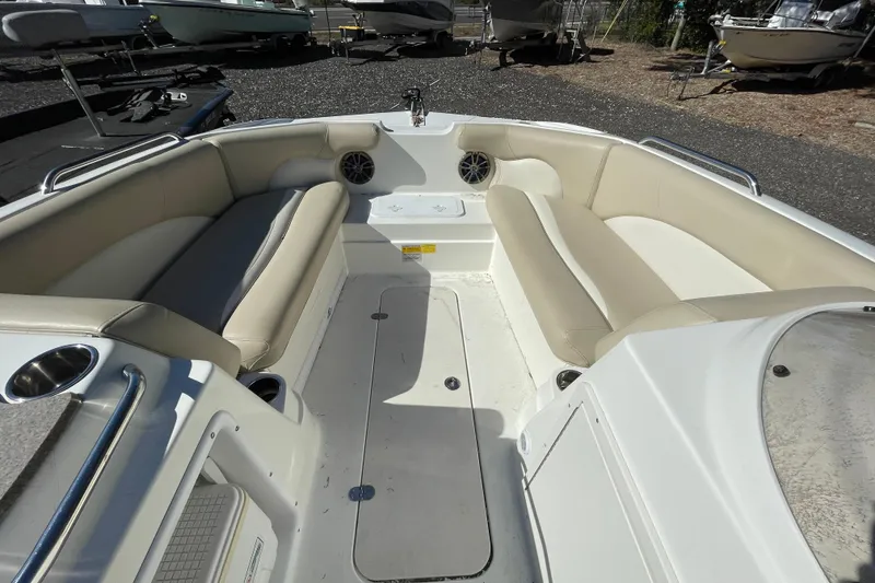 Slide: The Image of 2015 NauticStar 203SC Sport Deck interior with beige seating and cup holders. - 5