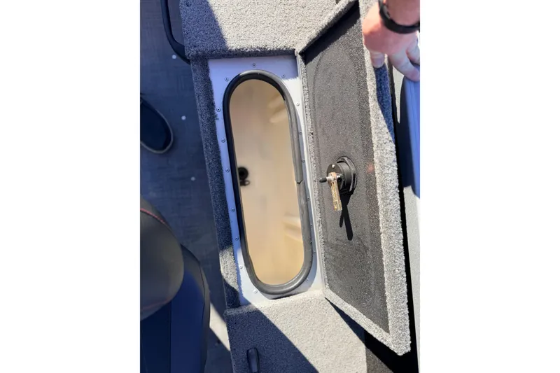 Slide: The Image of 2024 Alumacraft Competitor 175X Sport storage compartment with open hatch and key lock. - 19