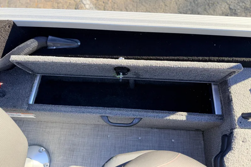 Slide: The Image of 2024 Alumacraft Competitor 175X Sport boat storage compartment, open and empty. - 22