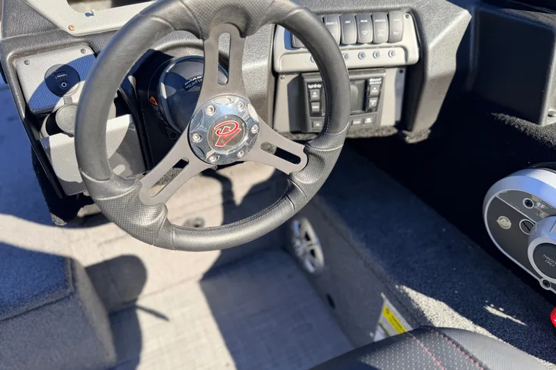 Slide: The Image of 2024 Alumacraft Competitor 175X Sport steering wheel and dashboard controls. - 23