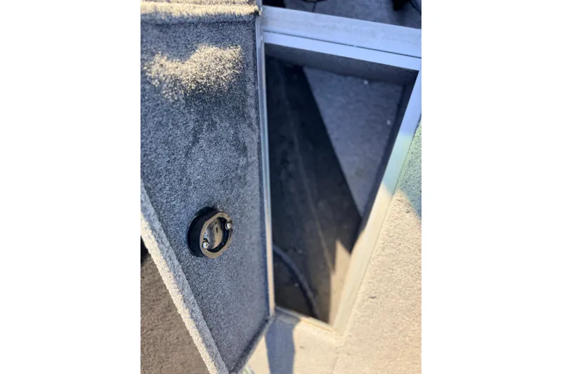 Slide: The Image of 2024 Alumacraft Competitor 175X Sport interior detail with carpeted surface and storage compartment. - 29