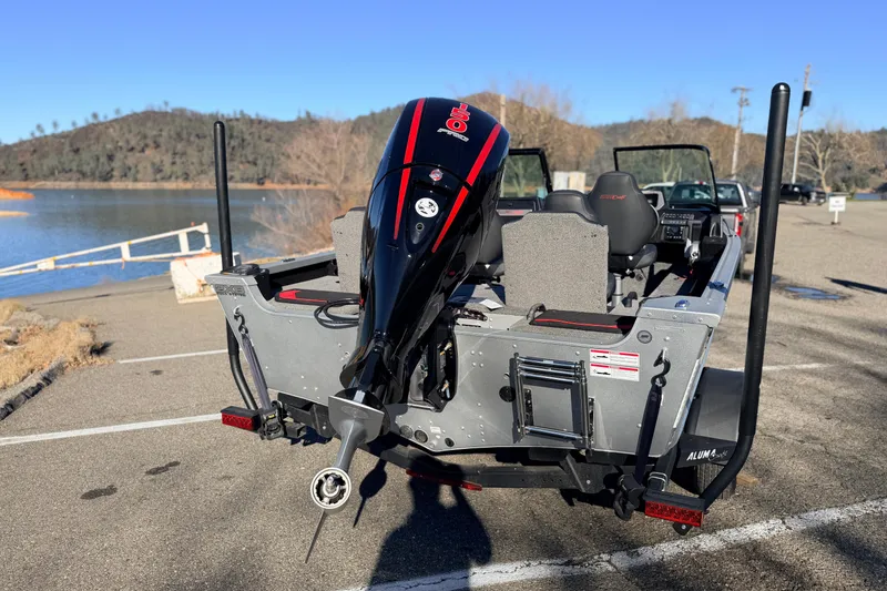 Slide: The Image of 2024 Alumacraft Competitor 175X Sport boat with outboard motor at lakeside. - 3