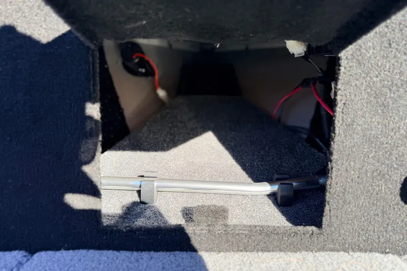 Slide: The Image of 2024 Alumacraft Competitor 175X Sport interior compartment with wiring and carpeted finish. - 31