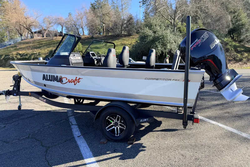 Slide: The Image of 2024 Alumacraft Competitor 175X Sport boat on trailer, parked outdoors. - 5