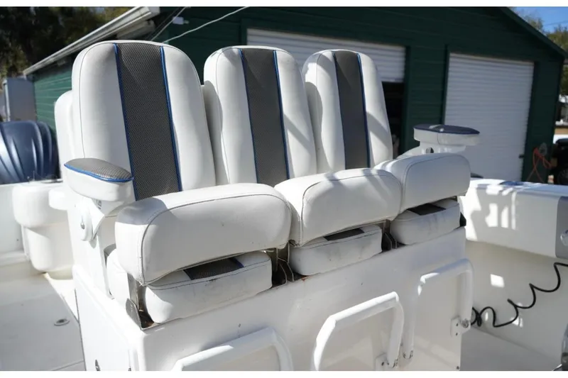 Slide: The Image of 2000 Contender 36 Open boat with white cushioned seats and armrests. - 12