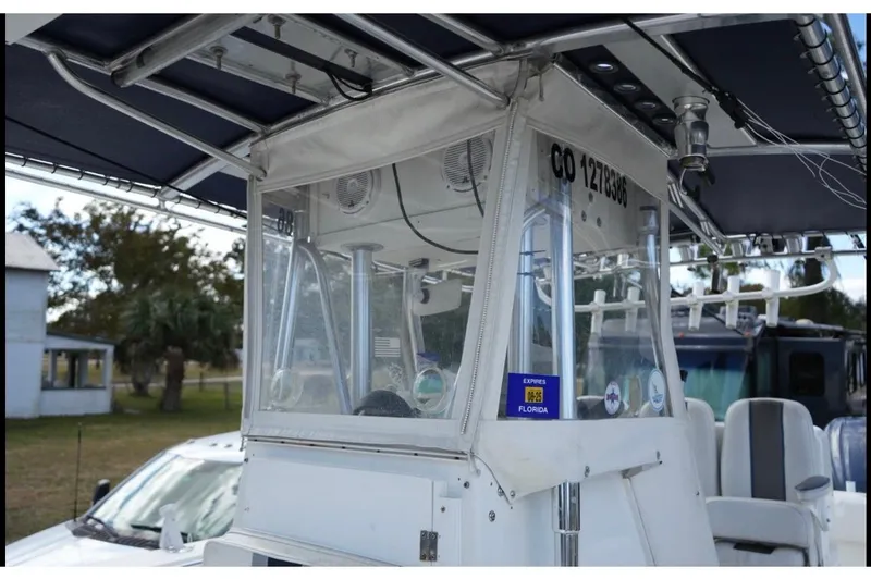 Slide: The Image of 2000 Contender 36 Open boat with enclosed helm, parked outdoors. - 20