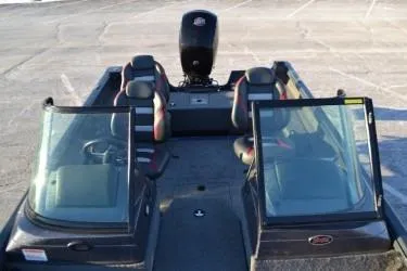 Slide: The Image of 2023 Ranger VS1782SC Angler boat with dual windshields and seating, parked on pavement. - 7