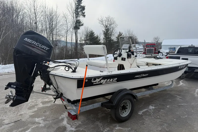 Slide: The Image of 2016 Mako Pro Skiff 17 CC boat on trailer with Mercury outboard motor. - 22