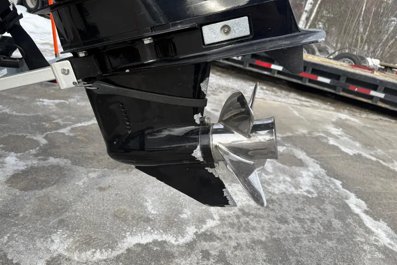 Slide: The Image of 2016 Mako Pro Skiff 17 CC boat propeller and lower unit on a snowy surface. - 30