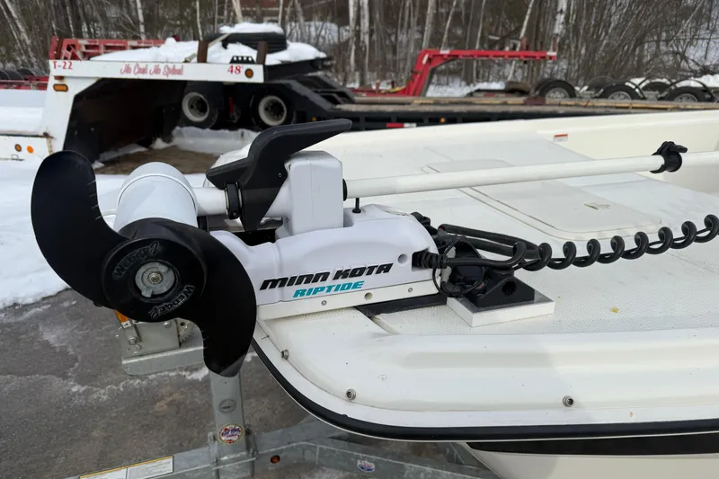 Slide: The Image of 2016 Mako Pro Skiff 17 CC with Minn Kota Riptide trolling motor on snowy trailer. - 32