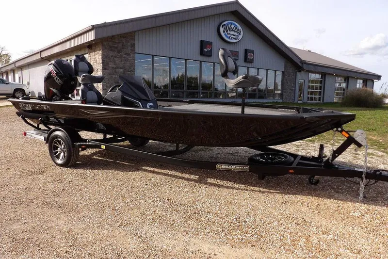 The Image of 2026 Crestliner XF 189 boat on trailer outside marine center. - 1