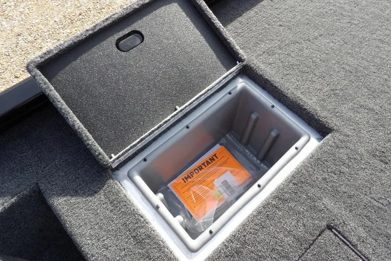 Slide: The Image of 2026 Crestliner XF 189 storage compartment with important documents inside. - 13