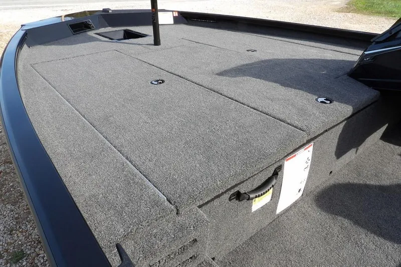 Slide: The Image of 2026 Crestliner XF 189 boat deck with carpeted surface and storage compartments. - 14