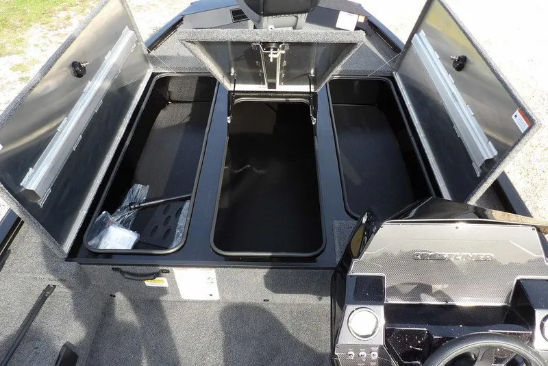 Slide: The Image of 2026 Crestliner XF 189 boat interior with open storage compartments and steering console. - 25