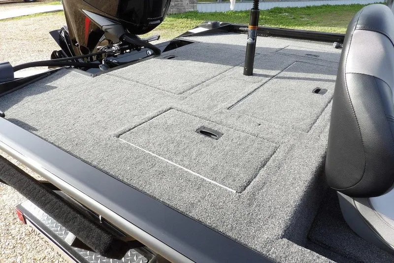 Slide: The Image of 2026 Crestliner XF 189 boat deck with carpeted storage compartments and seating. - 29