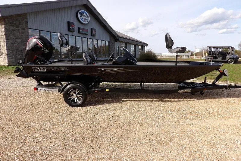 Slide: The Image of 2026 Crestliner XF 189 boat on trailer outside a marine center. - 3