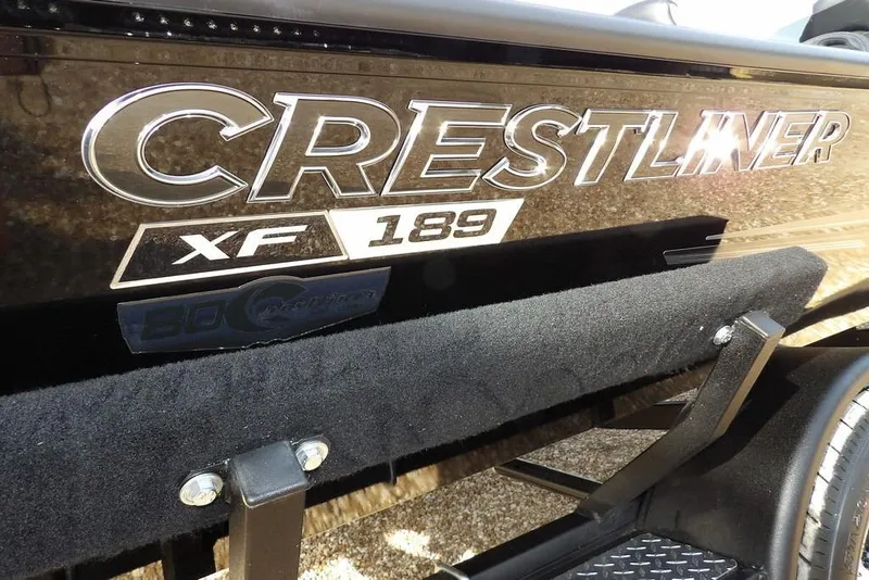 Slide: The Image of 2026 Crestliner XF 189 boat logo on a sleek black surface. - 40