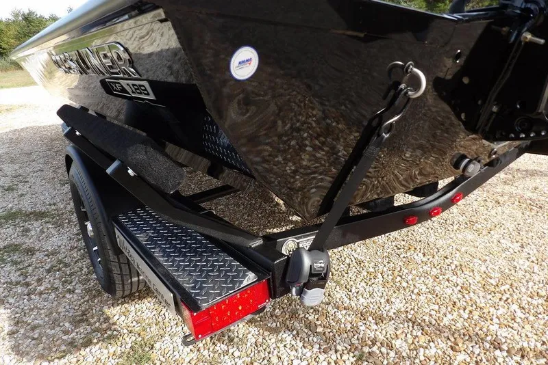 Slide: The Image of 2026 Crestliner XF 189 boat on trailer, featuring sleek black design and sturdy construction. - 41