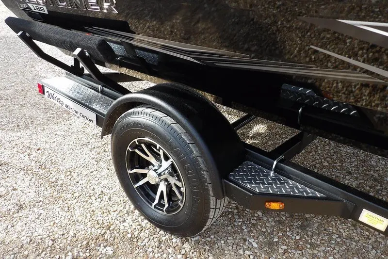 Slide: The Image of 2026 Crestliner XF 189 trailer with stylish alloy wheel on gravel surface. - 42