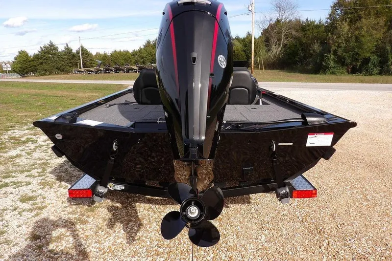 Slide: The Image of 2026 Crestliner XF 189 boat rear view with powerful outboard motor on gravel. - 5