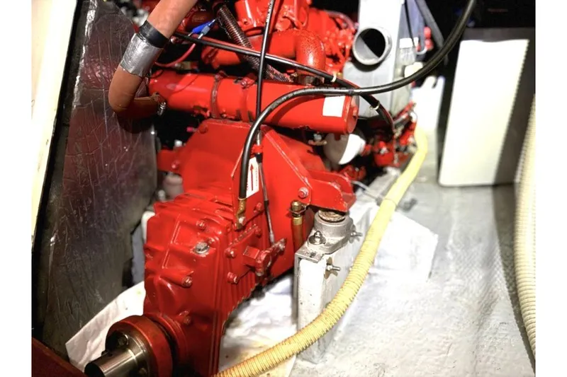 Slide: The Image of Engine compartment of a 1985 Nonsuch 30 Ultra sailboat, featuring a red engine. - 11