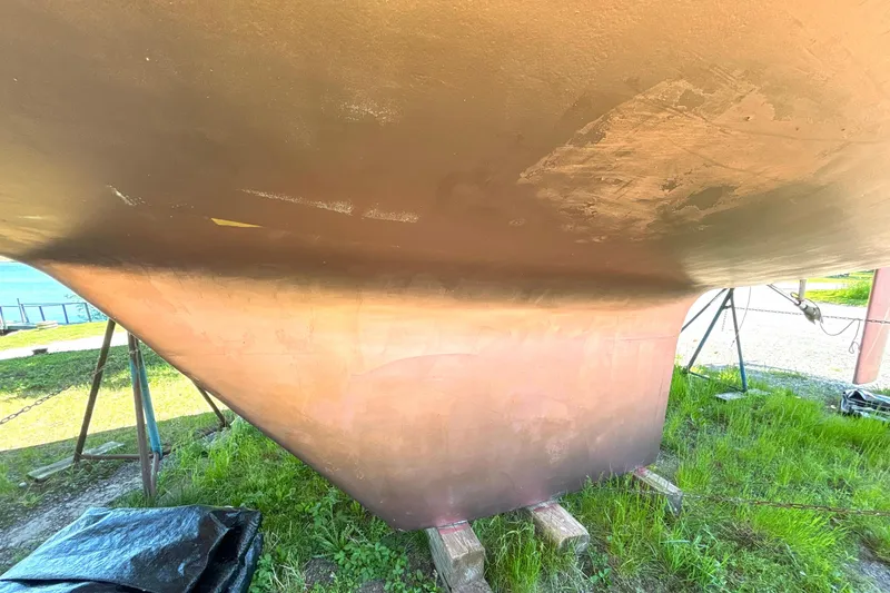 Slide: The Image of 1985 Nonsuch 30 Ultra sailboat hull on stands, showing keel and underbody. - 12