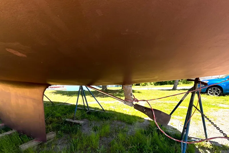 Slide: The Image of 1985 Nonsuch 30 Ultra sailboat hull on stands, showing keel and rudder. - 13