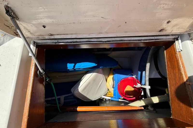 Slide: The Image of Storage compartment of a 1985 Nonsuch 30 Ultra sailboat, containing various boating equipment. - 29