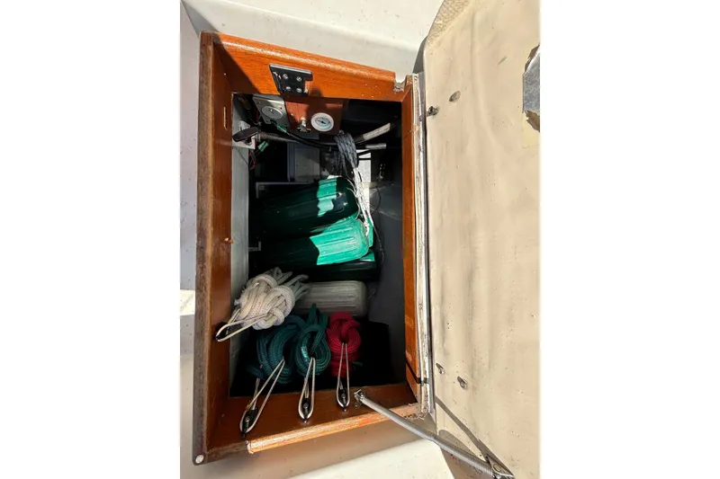 Slide: The Image of Storage compartment on a 1985 Nonsuch 30 Ultra sailboat with ropes and equipment. - 30