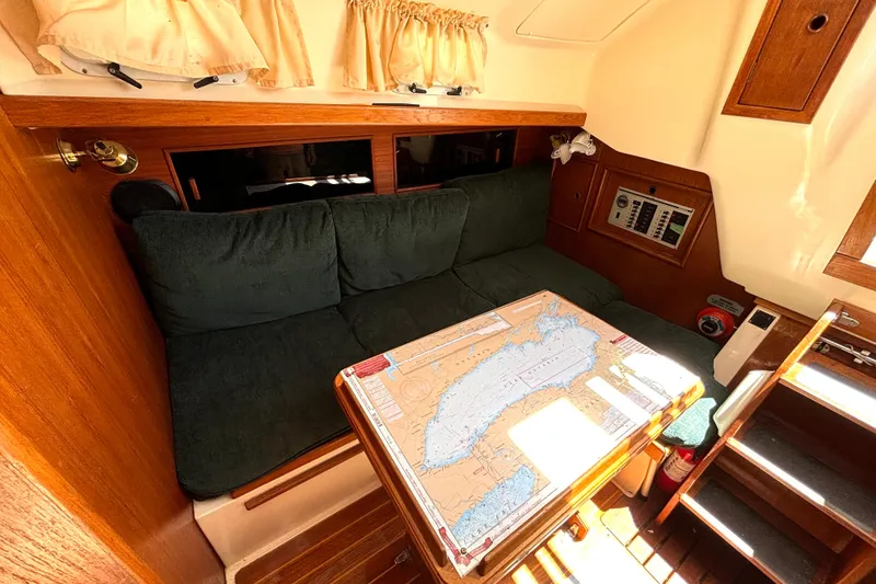 Slide: The Image of Cozy interior of 1985 Nonsuch 30 Ultra sailboat with chart table and seating area. - 32