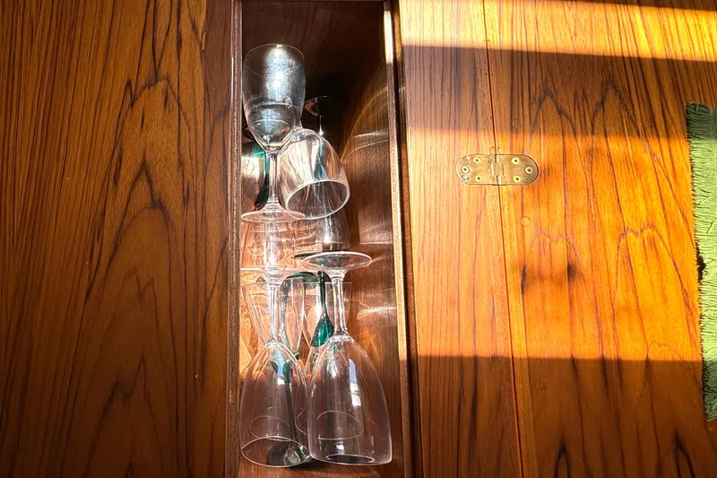 Slide: The Image of Wine glasses stored in a wooden cabinet on a 1985 Nonsuch 30 Ulta sailboat. - 34
