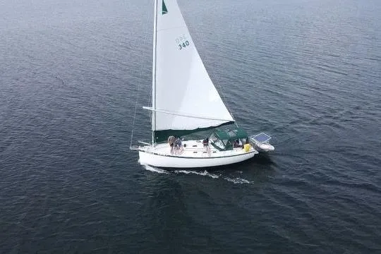 Slide: The Image of Sailboat Nonsuch 30 Ulta 1985 cruising on calm waters, aerial view. - 4