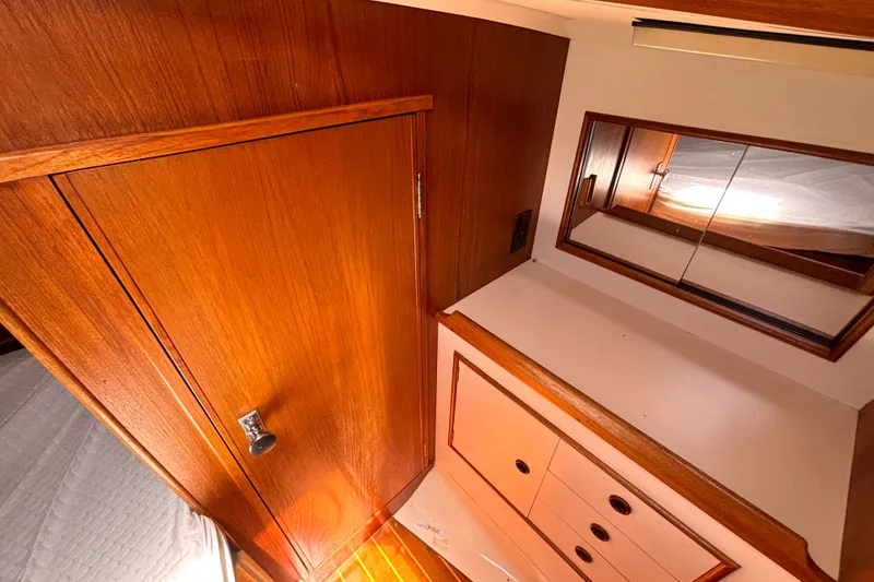 Slide: The Image of Interior of 1985 Nonsuch 30 Ultra sailboat with wooden cabinetry and mirror. - 42