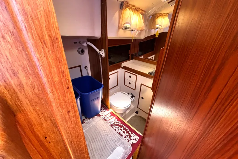 Slide: The Image of Interior of 1985 Nonsuch 30 Ultra sailboat bathroom with wood finish and compact design. - 45