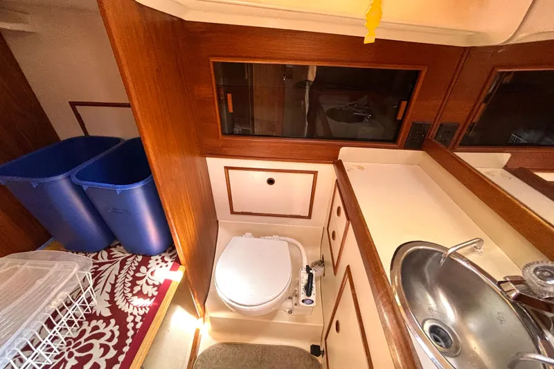 Slide: The Image of 1985 Nonsuch 30 Ultra yacht bathroom with sink, toilet, and storage. - 46