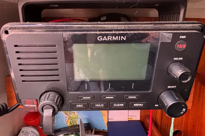 Slide: The Image of Garmin marine radio on 1985 Nonsuch 30 Ulta sailboat, featuring distress button and controls. - 49