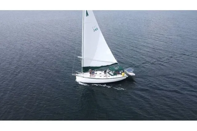 Slide: The Image of Sailing on calm waters, 1985 Nonsuch 30 Ultra sailboat with white sails. - 5