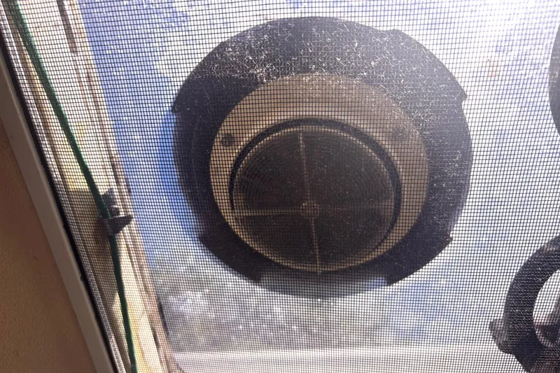 Slide: The Image of Ventilation fan viewed through a mesh screen on a 1985 Nonsuch 30 Ulta boat. - 50