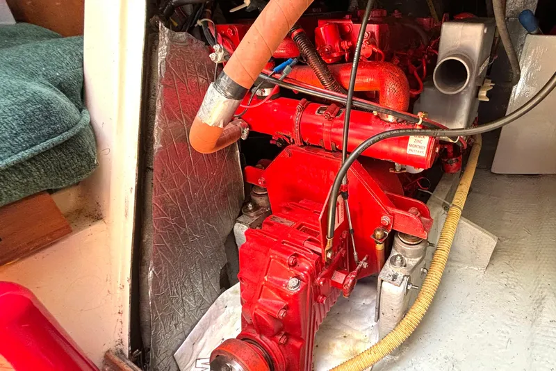 Slide: The Image of Engine compartment of a 1985 Nonsuch 30 Ultra sailboat, featuring a red marine engine. - 52