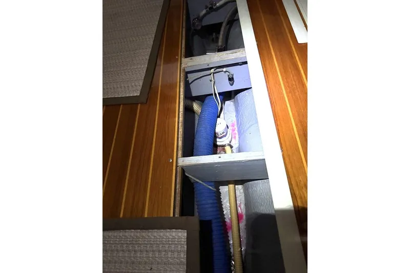 Slide: The Image of Interior view of 1985 Nonsuch 30 Ultra sailboat showing plumbing and wooden paneling. - 6