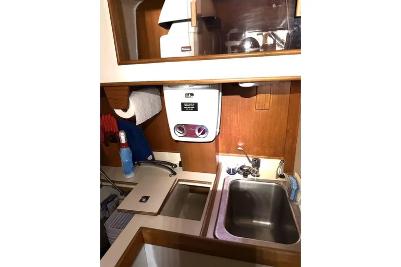 Slide: The Image of Compact galley kitchen in 1985 Nonsuch 30 Ultra sailboat with sink and storage. - 7