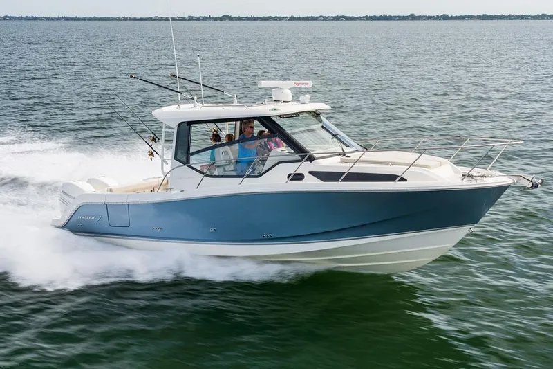 Slide: The Image of Manufacturer Provided Image: 2026 Boston Whaler 325 Conquest cruising on open water, showcasing sleek design and performance. - 2