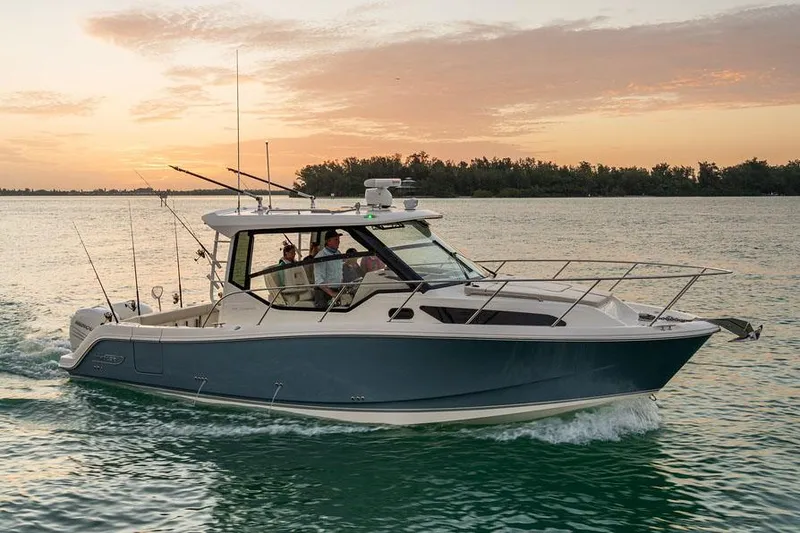 Slide: The Image of Manufacturer Provided Image: 2026 Boston Whaler 325 Conquest cruising at sunset on calm waters. - 3