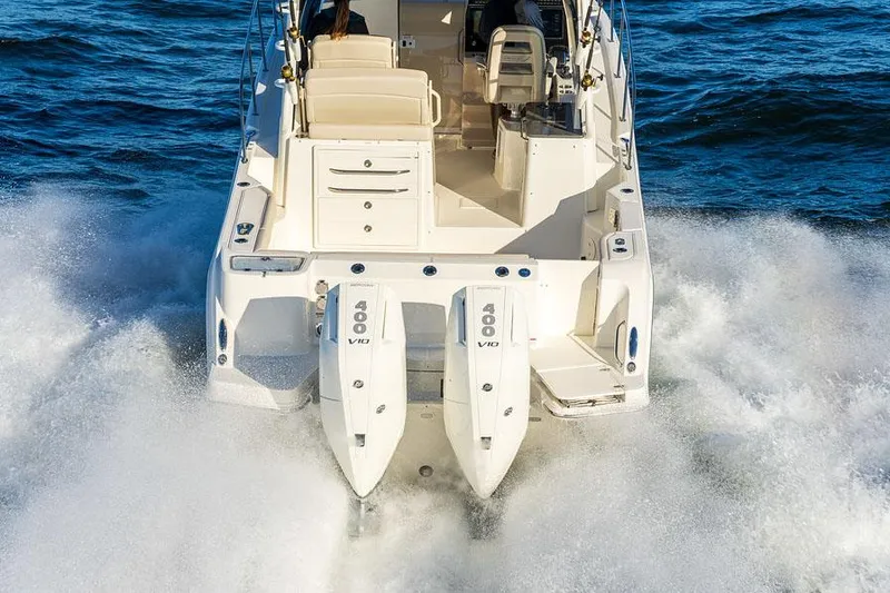 Slide: The Image of Manufacturer Provided Image: 2026 Boston Whaler 325 Conquest boat with dual 400 V8 engines cruising on water. - 5