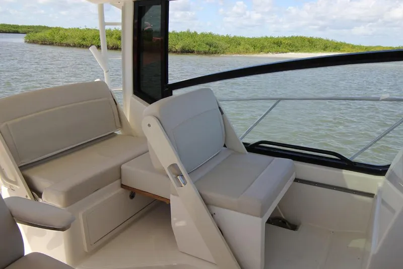 Slide: The Image of Manufacturer Provided Image: 2026 Boston Whaler 325 Conquest interior seating with scenic water view. - 7