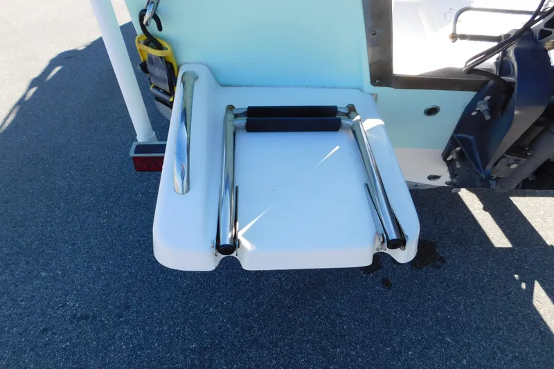Slide: The Image of 2019 Key West 1720 Center Console boat with a folded swim ladder on the deck. - 10